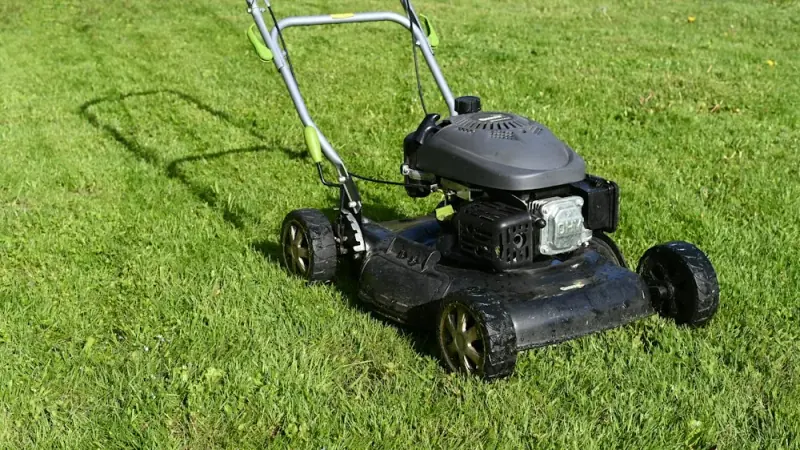 A push mower on a neatly cut green lawn